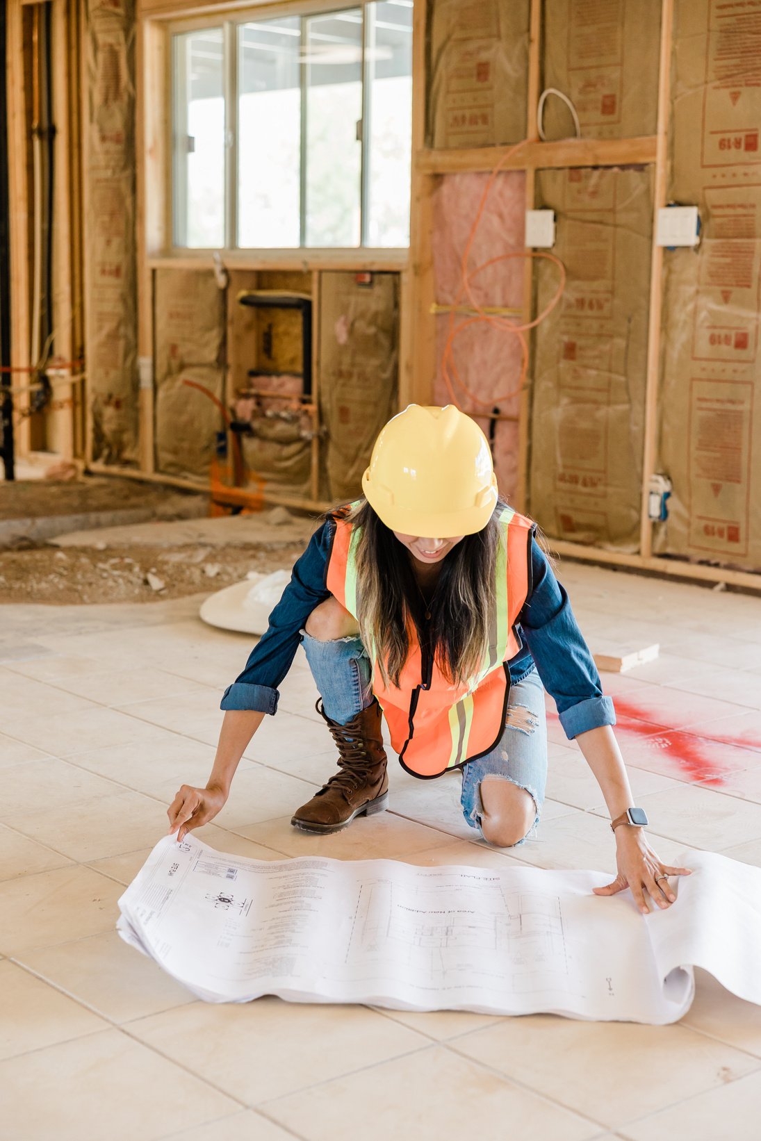 Woman Holding Blueprints